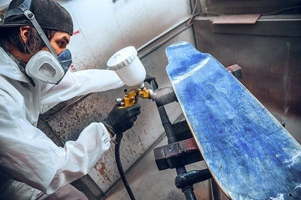 team spraying skate board