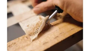 Upholsterer stretching fabric over restored bench seat