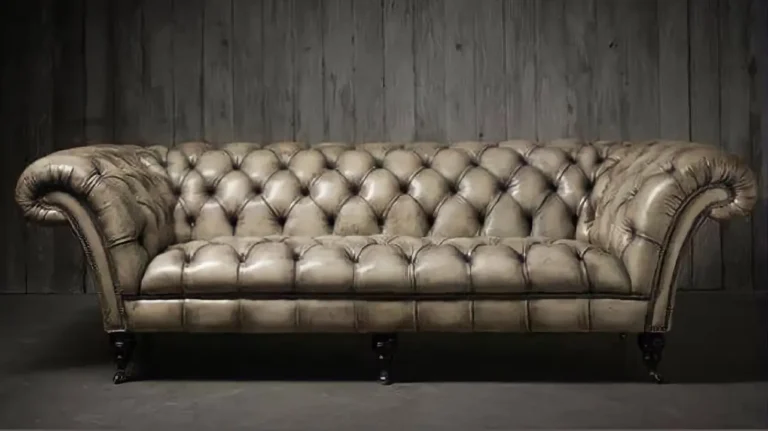 Luxury tufted sofa restored with stitched leather panels and brass accents