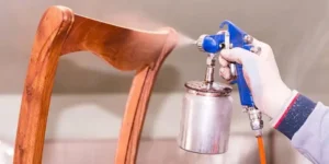 team members spraying chair