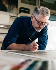 Craftsman inspecting CNC-cut components for quality control