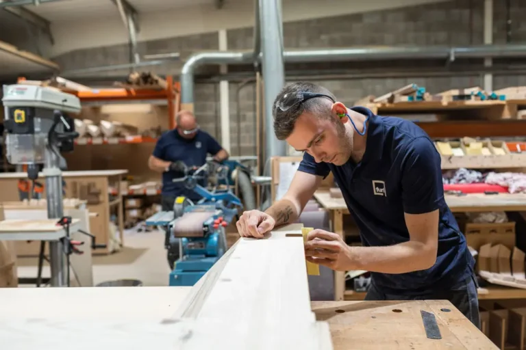 Technician applying edge banding to cabinet components
