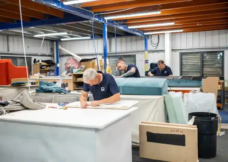 Team member cutting foam for commercial seating upholstery