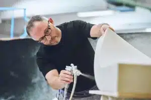 Team member cutting foam for bench seat rebuild