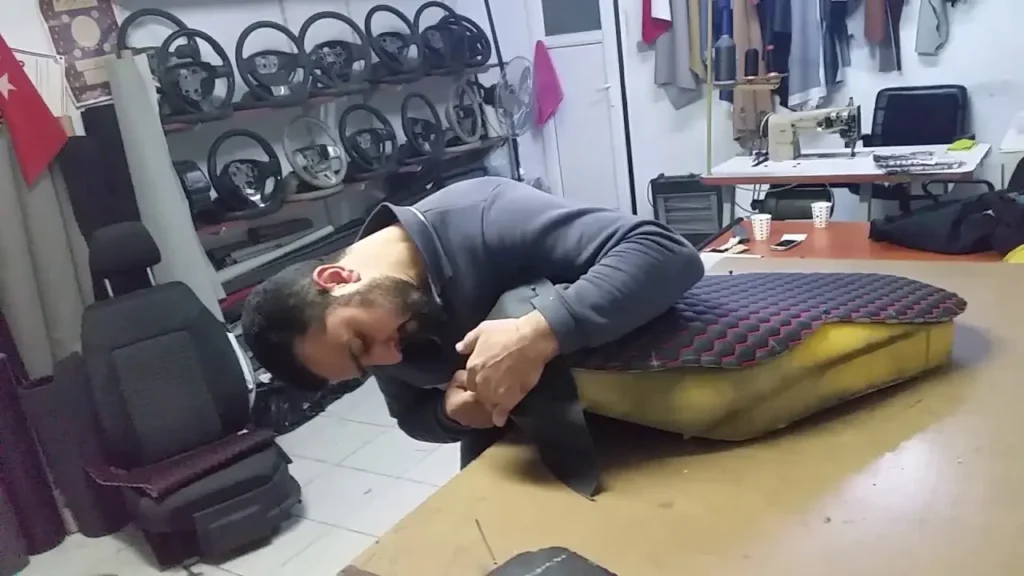 Technician installing marine upholstery on boat bench