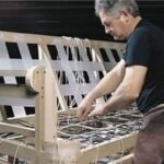 upholstery shop at First Class mastercraft — custom sofa detailing in progress