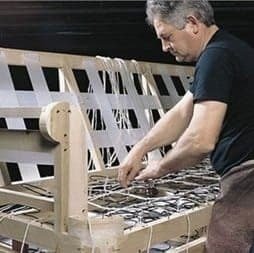 upholstery shop at First Class mastercraft — custom sofa detailing in progress